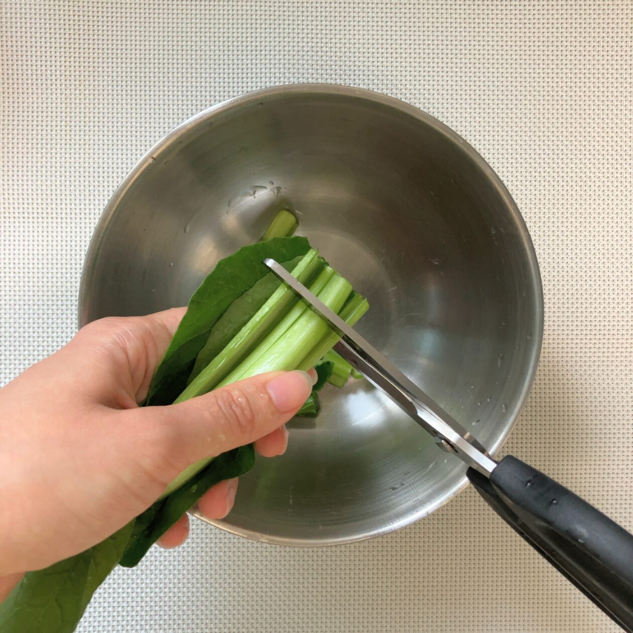 小松菜をはさみで切っている写真