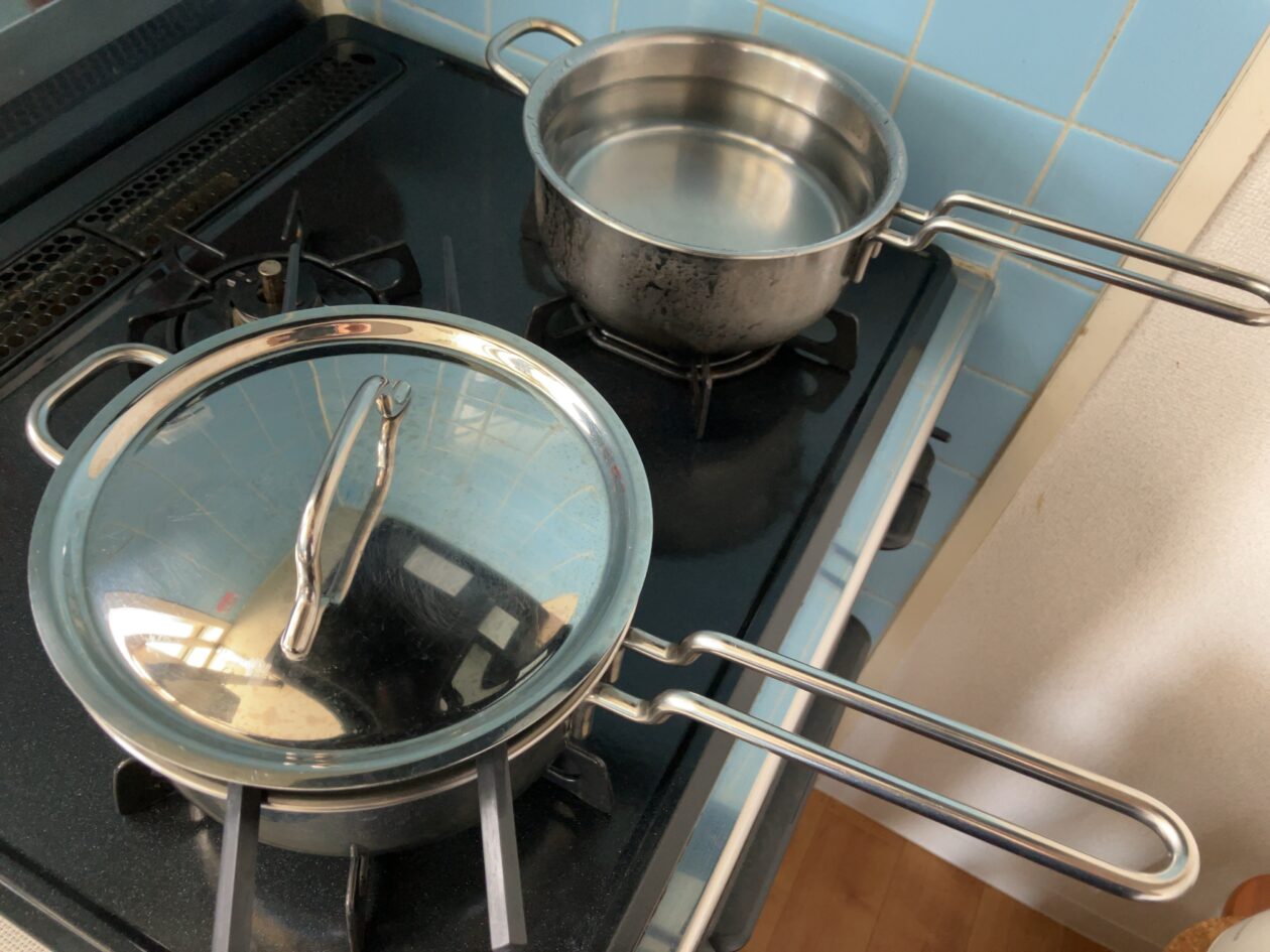 おかゆを作りながら湯を沸かしている写真